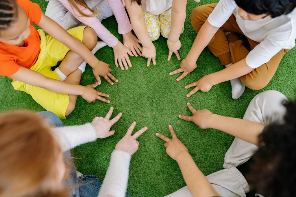 Afterschool club image of children sat in a circle having fun
